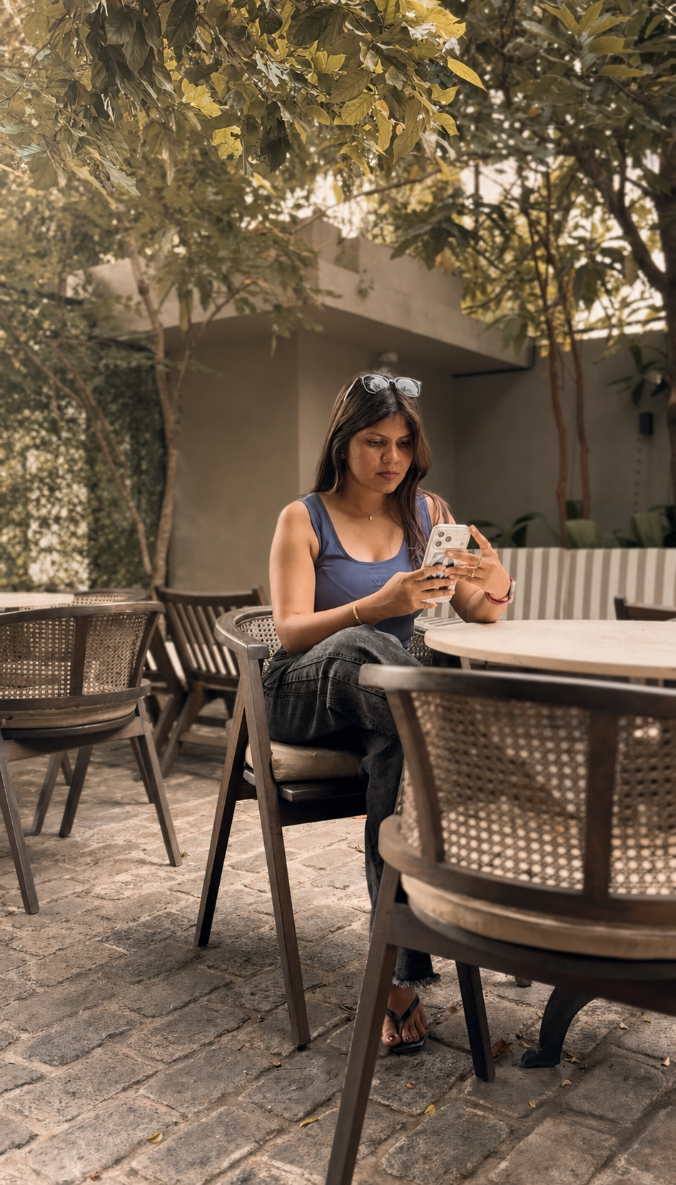 Pawani Manamperi, founder of Gigi's Clothing Co., in a tropical garden setting